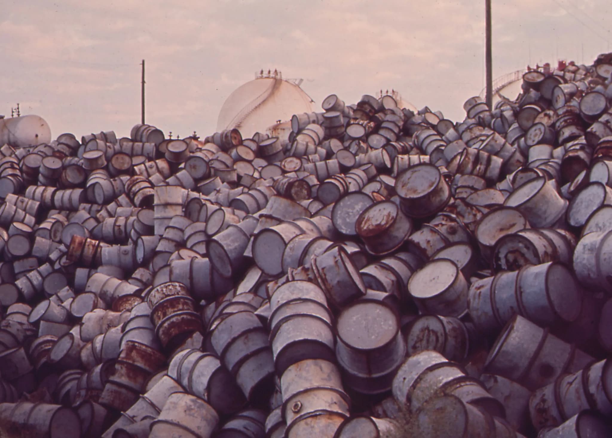 Weathered industrial waste drums at a remediation site